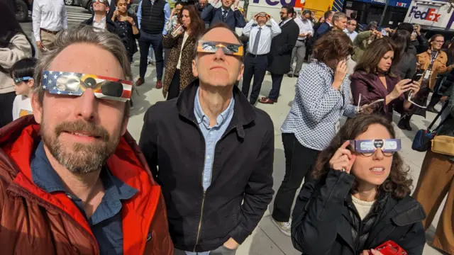 New York BBC staff looking at the eclipse