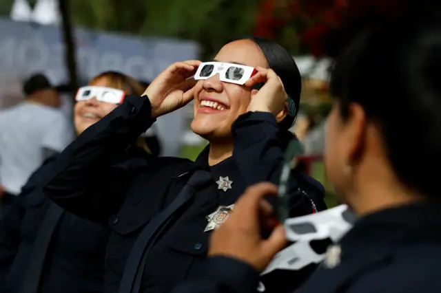 Police officers in Torreon, state of Coahuila, Mexico wear special glasses to view the solar eclipse