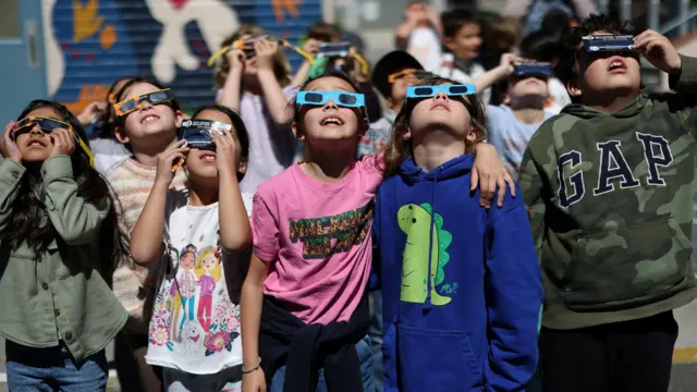 Students watch a partial solar eclipse at Benjamin Franklin Elementary Magnet School in Glendale, California, U.S.