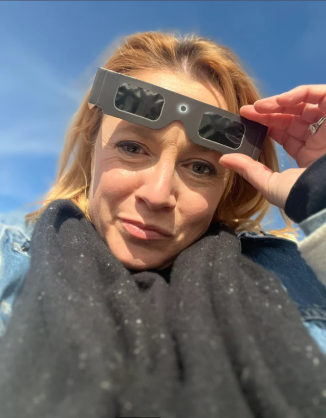 Isabelle Ethier wearing solar eclipse protective glasses.