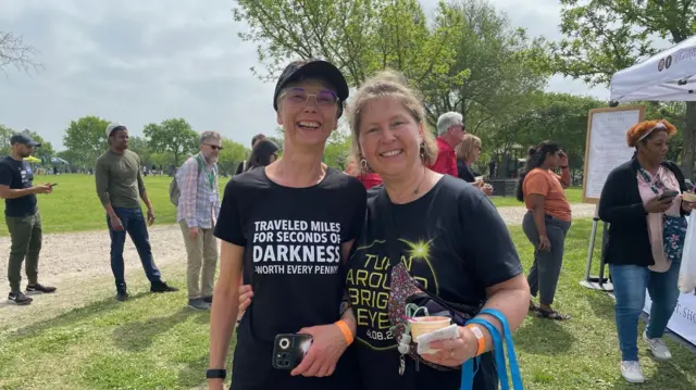 Two friends pose for a photo while they wait for the eclipse