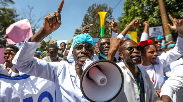 Kenyan intern doctors and medical practitioners shout slogans and hold placards during a protest against the government's failure to hire intern doctors and to demand better working terms including permanent employment, as they march to key government offices including the Ministry of Health and Parliament in Nairobi, Kenya, 22 March 2024