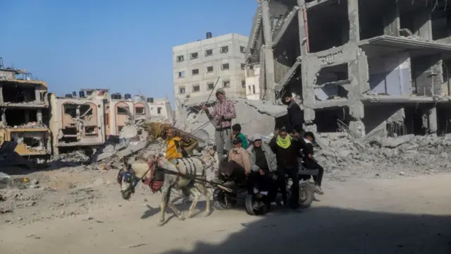 People inspect damage and remove items from their homes following Israeli airstrikes on April 07, 2024 in Khan Younis, Gaza.