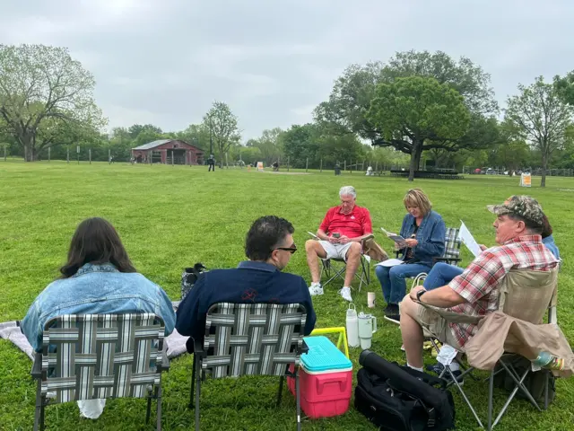 People sit on foldable chairs in park in Mesquite, Texas