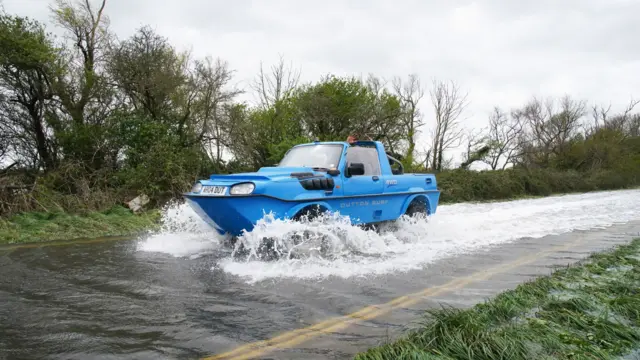 A Dutton Surf kit car being driven through flood water in Littlehampton