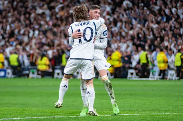 Modric is hugged by Valverde after his pass