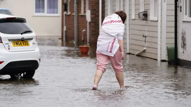 A resident of Rope Walk in Littlehampton wades through flood water