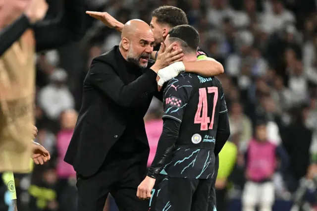 Guardioal celebrates with Foden after his goal