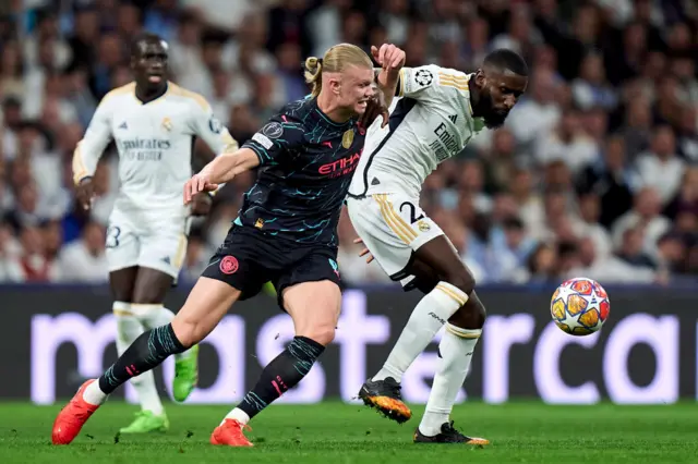 Rudiger and Haaland battle for the ball