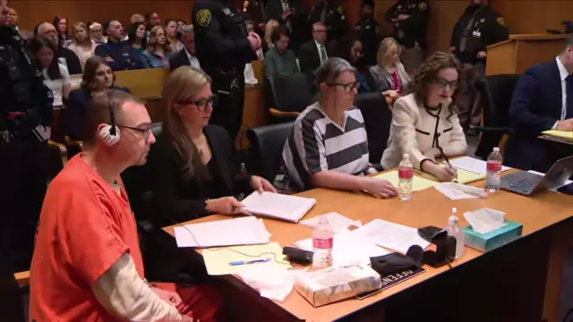 Four people sitting in a court room