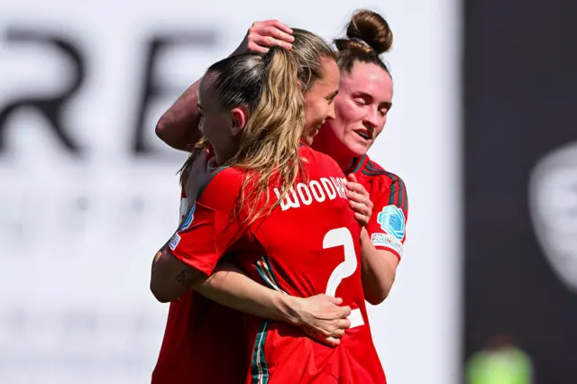 Wales players celebrate with Kayleigh Barton