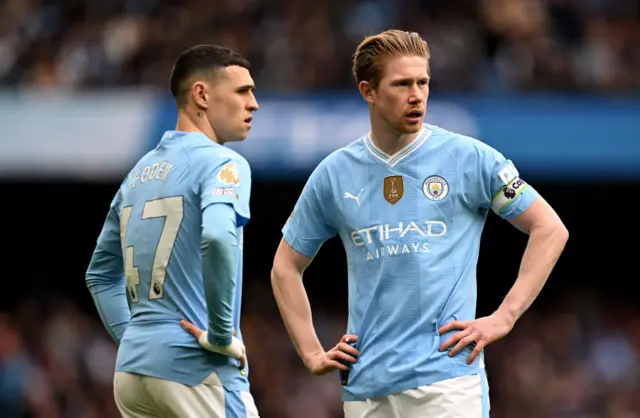 Foden and De Bruyne stand over a free kick