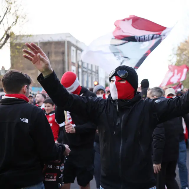 Arsenal fan with club scarf around his face