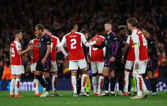 Players shake hands on the pitch at the end