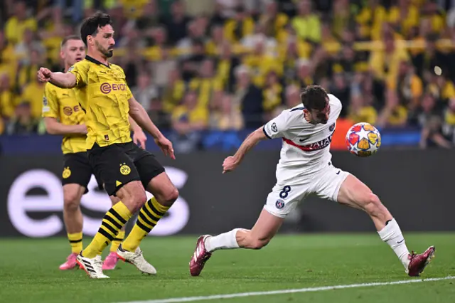 Fabian Ruiz of Paris Saint-Germain headers the ball whilst under pressure from Mats Hummels