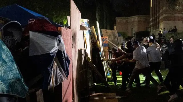 Counter protesters attack a pro-Palestinian encampment set up on the campus of the University of California Los Angeles