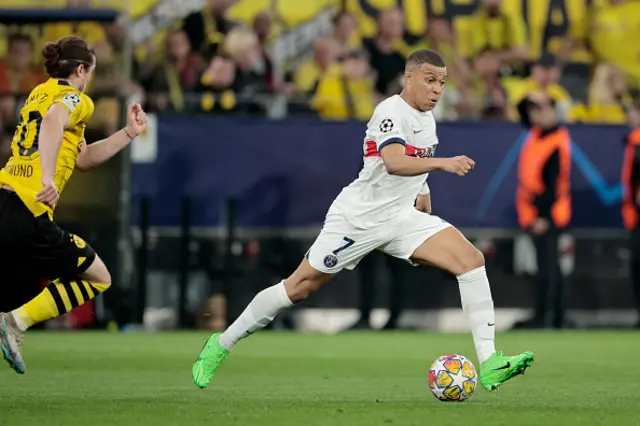 Marcel Sabitzer of Borussia Dortmund pursues Kylian Mbappe