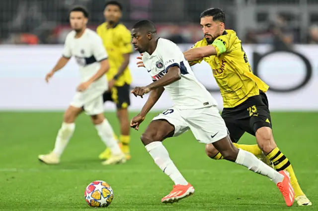 Ousmane Dembele and Dortmund's German midfielder Emre Can vie for the ball