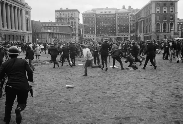 Policemen chase crowd of anti-war demonstrators on the campus of Columbia University