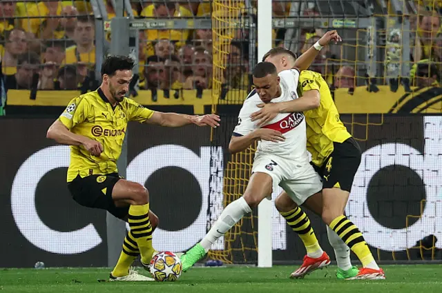 Kylian Mbappe (C) vies for the ball with Dortmund's German defender #15 Mats Hummels (L) and Dortmund's German defender #04 Nico Schlotterbeck