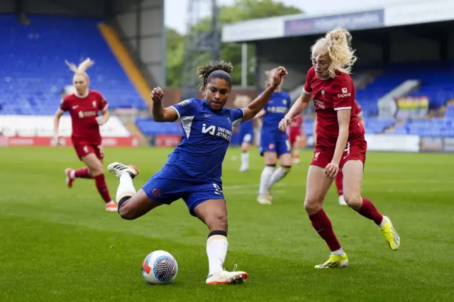 Chelsea's Catarina Macario (centre) and Liverpool's Grace Fisk battle for the ball during the Barclays Women's Super League match at Prenton Park, Birkenhead.