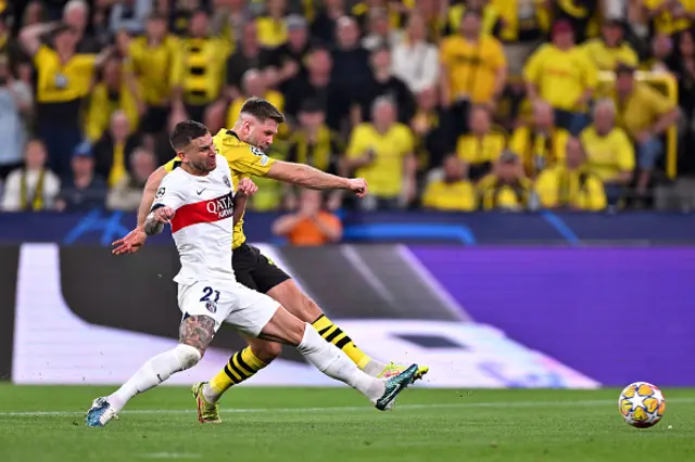 Niclas Fuellkrug of Borussia Dortmund scores his team's first goal whilst under pressure from Lucas Hernandez