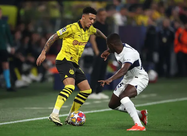 Jadon Sancho of Borussia Dortmund on the ball whilst under pressure from Nuno Mendes