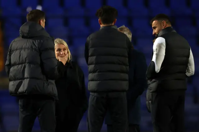 Hayes chats to her coaching staff on the pitch at the end of the game