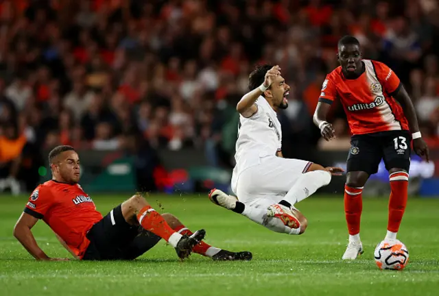 Lucas Paqueta of West Ham United is fouled by Carlton Morris