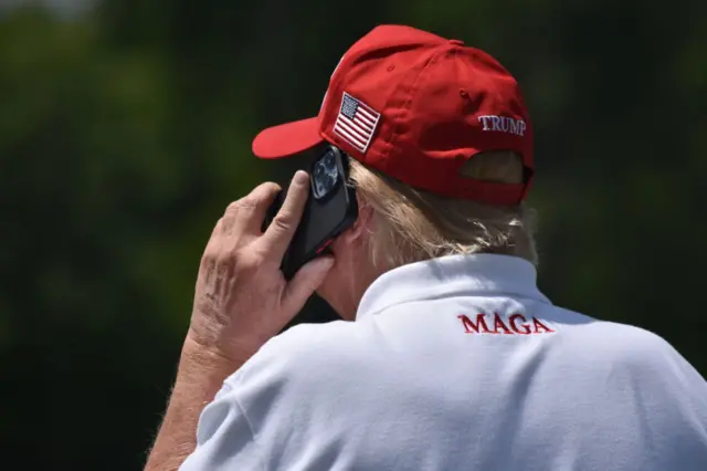 Donald Trump on the phone while golfind