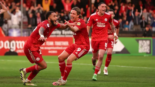 Crawley celebrate a goal against MK Dons