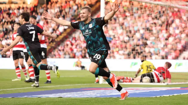 Elliott Nevitt celebrates after James Maxwell's own goal