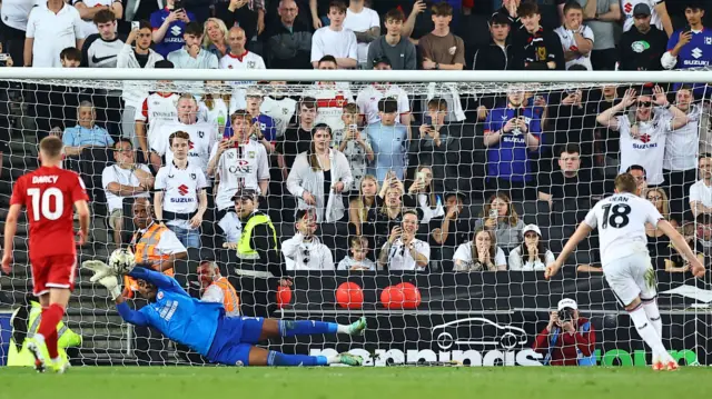 Crawley Town keeper Corey Addai saves a penalty kick from MK Dons' Max Dean