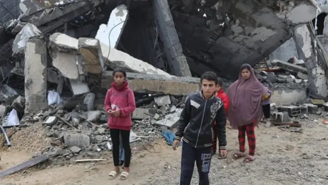 Palestinian children walk around the rubble of buildings destroyed after an Israeli attack on As Salam Neighborhood in Rafah, Gaza on 6 May 06 2024