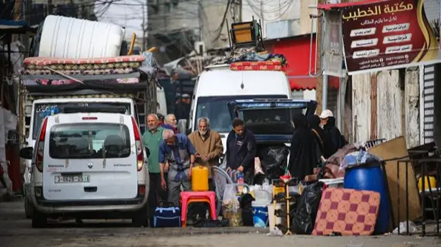 Palestinians gather their belongings as they flee Rafah in the southern Gaza Strip to a safer location on 11 May 2024