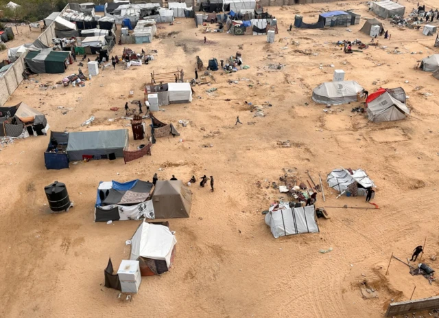 Displaced Palestinians are evacuating a tent camp in Rafah ahead of the Israeli offensive, 11 May 2024