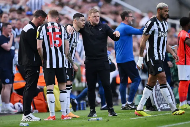 Eddie Howe, Manager of Newcastle United, talks to Miguel Almiron as he is substituted on during the Premier League match between Newcastle United and Brighton & Hove Albion