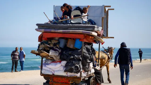 Palestinians evacuate after Israeli forces launched a ground and air operation in the eastern part of Rafah