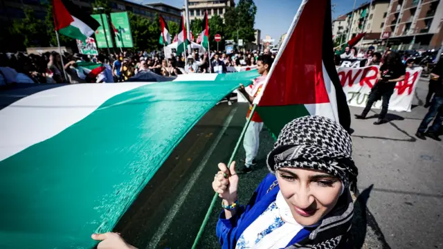 People attend a demonstration in support of the Palestinian people outside the Turin International Book Fair, in Turin, northern Italy