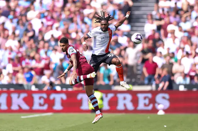 Emerson Palmieri of West Ham United battles for possession with Fred Onyedinma