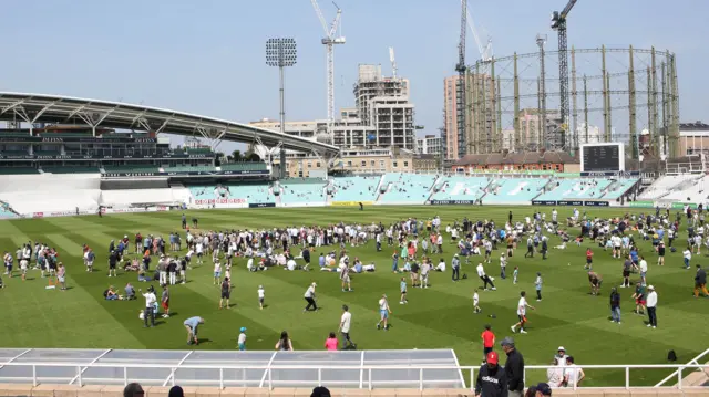 People on pitch at Kia Oval