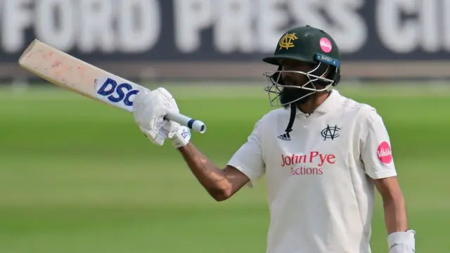 Haseeb Hameed raises his bat upon reaching his hundred