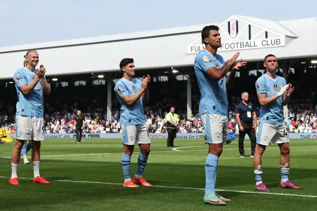 Manchester City players applaud the fans