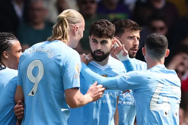 Manchester City's defender Josko Gvardiol (C) celebrates with teammates after scoring the opening goal