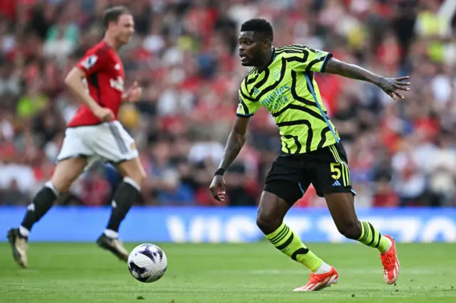 Thomas Partey runs with the ball during the English Premier League football match between Manchester United and Arsenal