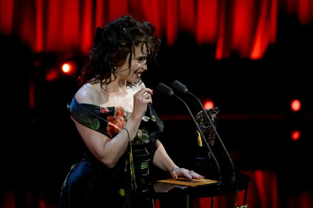 Helena Bonham-Carter accepts the award for supporting actor on behalf of Matthew Macfayden