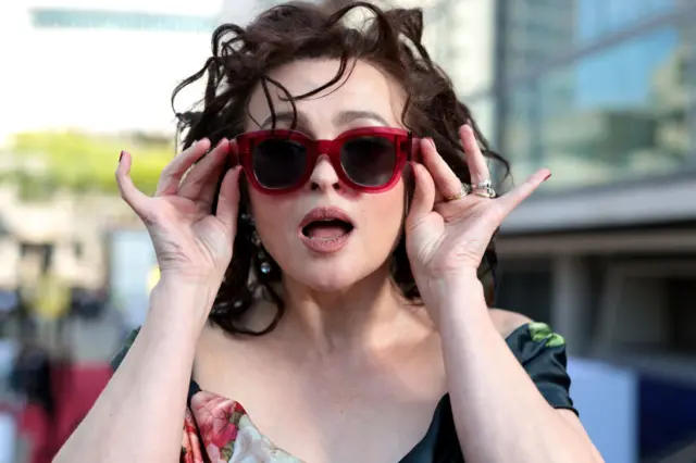 Helena Bonham Carter was prepared for the British sunshine with her sunglasses on the red carpet