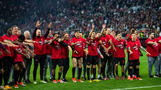 Bayer Leverkusen players celebrate with their fans