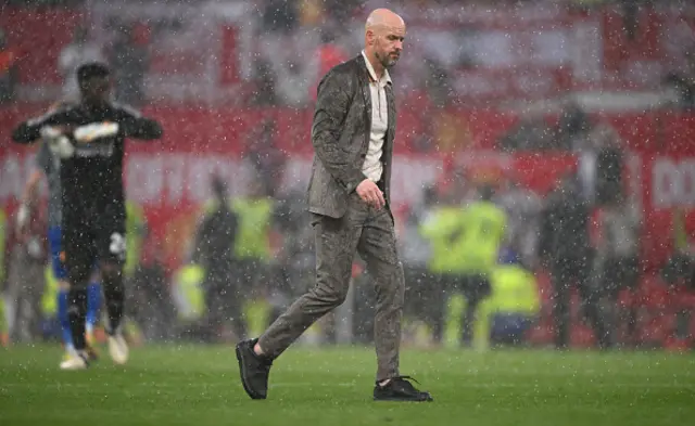 Erik ten Hag, Manager of Manchester United, leaves the field in the rain