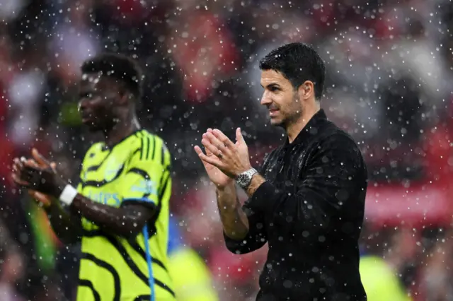 Mikel Arteta, Manager of Arsenal, applauds the fans as he celebrates victory after the Premier League match between Manchester United and Arsenal FC